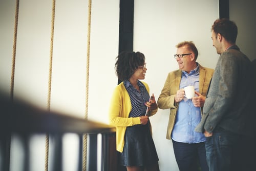 group of three people chatting casually