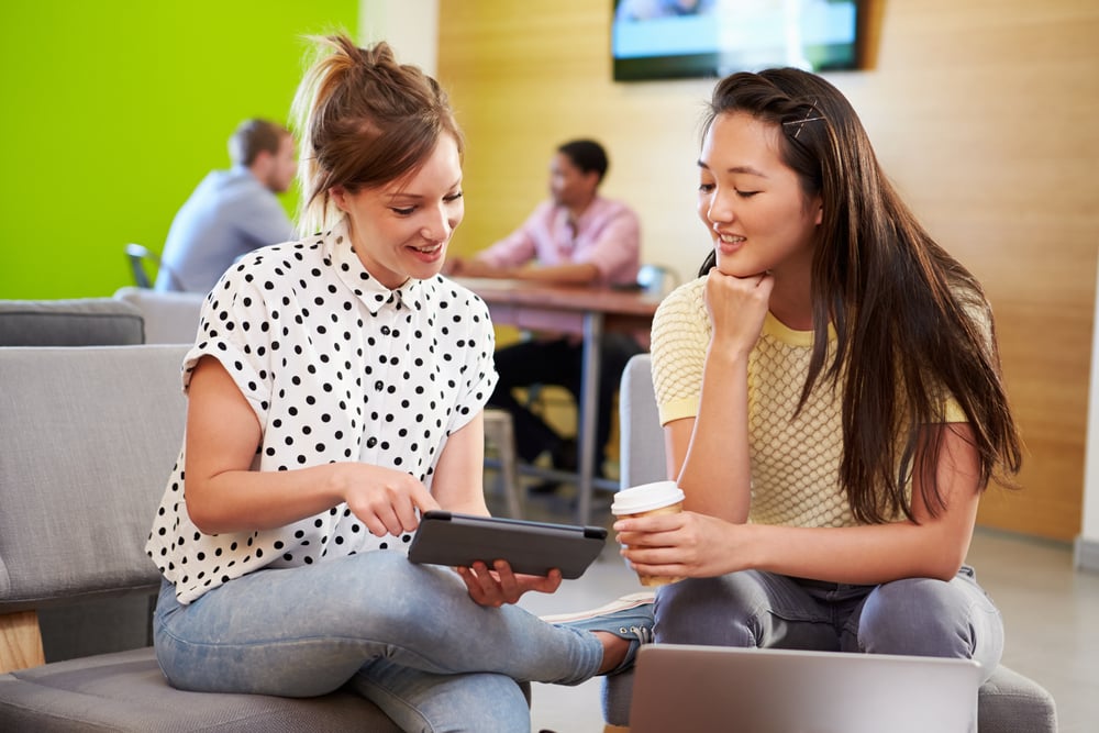 Two Hybrid Employees Meeting in an Office Space